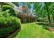 Well-maintained backyard with mature trees and manicured lawn at 2202 Lattimore Farm Nw Dr, Kennesaw, GA 30152