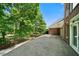 View of the home's brick facade and extended stone patio with iron railing at 2202 Lattimore Farm Nw Dr, Kennesaw, GA 30152