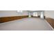 Large basement with paneled wainscoting and multiple doors leading to the exterior at 2202 Lattimore Farm Nw Dr, Kennesaw, GA 30152