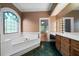 Bathroom featuring a soaking tub, stained glass window, and and vanity at 2202 Lattimore Farm Nw Dr, Kennesaw, GA 30152