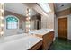 Bathroom with a soaking tub, stained glass, double sinks, and a large mirror at 2202 Lattimore Farm Nw Dr, Kennesaw, GA 30152