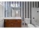 Bathroom with vanity, mirror, commode and tub-shower featuring striped wallpaper at 2202 Lattimore Farm Nw Dr, Kennesaw, GA 30152
