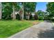 Elegant brick home featuring a manicured lawn and mature trees, offering a classic curb appeal at 2202 Lattimore Farm Nw Dr, Kennesaw, GA 30152