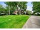 Beautiful two-story brick home with a manicured lawn, mature trees, and a long driveway at 2202 Lattimore Farm Nw Dr, Kennesaw, GA 30152