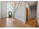 Light-filled foyer showcasing hardwood floors, a grand staircase, and a decorative front door at 2202 Lattimore Farm Nw Dr, Kennesaw, GA 30152