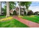 Beautiful brick home featuring manicured lawn, mature trees and a brick walkway at 2202 Lattimore Farm Nw Dr, Kennesaw, GA 30152