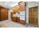 Traditional kitchen with wooden cabinets, tiled floors, and floral wallpaper at 2202 Lattimore Farm Nw Dr, Kennesaw, GA 30152