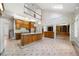 Bright, open kitchen with an island, wooden cabinets, and floral wallpaper at 2202 Lattimore Farm Nw Dr, Kennesaw, GA 30152