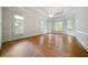 Spacious living room with hardwood floors, large windows, and tray ceilings at 2202 Lattimore Farm Nw Dr, Kennesaw, GA 30152