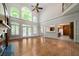 Bright living room with high ceilings, large windows, and seamless access to the kitchen at 2202 Lattimore Farm Nw Dr, Kennesaw, GA 30152