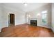 Spacious living room with hardwood floors, fireplace, and ample natural light from the windows at 2202 Lattimore Farm Nw Dr, Kennesaw, GA 30152