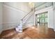 Foyer featuring hardwood floors, staircase, chandelier, and an abundance of natural light at 2202 Lattimore Farm Nw Dr, Kennesaw, GA 30152