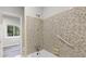 Bathroom showing tile shower with grab bar and tile walls at 2544 Overlook Dr, Atlanta, GA 30344