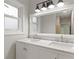 Bright bathroom with double sink vanity, marble countertops, and modern lighting fixture at 2544 Overlook Dr, Atlanta, GA 30344