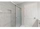 Bathroom with glass door shower featuring marble style tiling at 2544 Overlook Dr, Atlanta, GA 30344