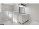 Bathroom featuring a double sink vanity with elegant fixtures and a glass-enclosed shower at 2544 Overlook Dr, Atlanta, GA 30344