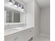 Bright bathroom with double sink vanity, marble countertops, and modern lighting fixture at 2544 Overlook Dr, Atlanta, GA 30344