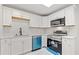 Modern kitchen featuring white cabinetry, stainless steel appliances, quartz countertops, and a bright, airy feel at 2544 Overlook Dr, Atlanta, GA 30344