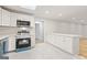 Well-lit kitchen featuring sleek appliances, white cabinets, and a convenient island with marble countertop at 2544 Overlook Dr, Atlanta, GA 30344