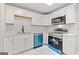 Close-up of a modern kitchen with white cabinetry, stainless steel appliances, and marble countertops at 2544 Overlook Dr, Atlanta, GA 30344