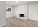 Living room featuring a decorative white brick fireplace, wood floors, and natural light at 2544 Overlook Dr, Atlanta, GA 30344