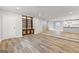 Spacious living room with hardwood floors, built-in bookshelves, and an open layout to the kitchen at 2544 Overlook Dr, Atlanta, GA 30344