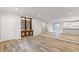 Spacious living room with hardwood floors, built-in shelving, and a freshly painted exposed brick partition at 2544 Overlook Dr, Atlanta, GA 30344