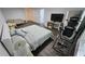 Expansive bedroom features hardwood floors, a comfortable seating area, and space for exercise equipment at 1338 Barrett Bluff Dr, Lawrenceville, GA 30045