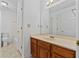 Well-lit bathroom with a large mirror, a wooden vanity, and a clean, functional design at 2209 N Forest Trl, Atlanta, GA 30338