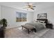 Relaxing bedroom featuring a ceiling fan, a large window with natural light, and a comfortable bed at 2209 N Forest Trl, Atlanta, GA 30338