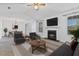 Cozy living room with a fireplace, large windows, and a view of the adjacent dining area at 2209 N Forest Trl, Atlanta, GA 30338