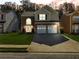 Charming two-story home with brick accents, a well-manicured lawn, and a spacious two-car garage at 2304 Stancrest Ln, Lawrenceville, GA 30044
