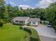 Charming home featuring a well-manicured lawn, fountain, and a welcoming covered porch at 4017 S South Bogan Road Rd, Buford, GA 30519