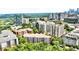 Residential community surrounded by lush greenery and city buildings featuring rooftop patios at 211 Colonial Homes Nw Dr # 1102, Atlanta, GA 30309