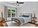 Cozy bedroom featuring a large window, ceiling fan and hardwood floors at 211 Colonial Homes Nw Dr # 1102, Atlanta, GA 30309