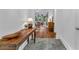 Inviting entryway with hexagon tile floor, wooden table, and views of the living area filled with natural light at 211 Colonial Homes Nw Dr # 1102, Atlanta, GA 30309