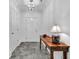 Elegant entryway featuring grey hexagon tile floor, wooden table, and white walls, creating a bright and welcoming space at 211 Colonial Homes Nw Dr # 1102, Atlanta, GA 30309