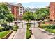 Beautiful exterior view of the luxurious condo building with manicured landscaping and gated entrance at 211 Colonial Homes Nw Dr # 1102, Atlanta, GA 30309