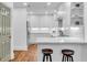 Modern kitchen with white cabinets, stainless steel appliances, and bar stool seating at 211 Colonial Homes Nw Dr # 1102, Atlanta, GA 30309