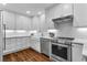 Bright kitchen featuring white cabinets, stainless steel appliances, and farmhouse sink at 211 Colonial Homes Nw Dr # 1102, Atlanta, GA 30309
