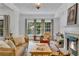Cozy living room with hardwood floors, fireplace, and plenty of natural light, offering a comfortable and inviting space at 211 Colonial Homes Nw Dr # 1102, Atlanta, GA 30309