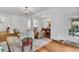 Open-concept living room with hardwood floors, dining area, and seamless flow to outdoor patio, ideal for entertaining at 211 Colonial Homes Nw Dr # 1102, Atlanta, GA 30309
