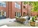 Relaxing outdoor patio featuring a sofa, chairs, and stylish rug, offering a comfortable space for outdoor living at 211 Colonial Homes Nw Dr # 1102, Atlanta, GA 30309