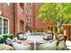 Charming patio area with outdoor seating and brick building at 211 Colonial Homes Nw Dr # 1102, Atlanta, GA 30309