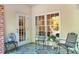 Cozy outdoor patio featuring comfortable chairs, side table, and fan with tranquil view at 211 Colonial Homes Nw Dr # 1102, Atlanta, GA 30309
