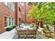 Cozy patio features comfortable seating, potted plants, and elegant brick architecture, creating a serene outdoor space at 211 Colonial Homes Nw Dr # 1102, Atlanta, GA 30309