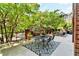 Charming outdoor patio with a dining table, chairs, and a patterned rug, surrounded by lush greenery for added privacy at 211 Colonial Homes Nw Dr # 1102, Atlanta, GA 30309