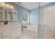 The main bath features a soaking tub, double sink vanity, and glass-enclosed shower at 2983 Albright Nw Commons, Kennesaw, GA 30144