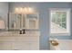 Bathroom featuring double vanity with marble countertop and decorative lighting at 2983 Albright Nw Commons, Kennesaw, GA 30144