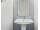 Powder room with a single sink and neutral-colored walls, featuring a modern faucet and mirror at 2983 Albright Nw Commons, Kennesaw, GA 30144